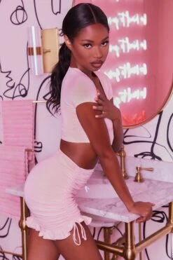 Ruched Bodycon Mini Skirt In Blush 15 Ruched Bodycon Mini Skirt In Blush -Glam Dress Store 3400 no ties 3409 here for the frill 7 blush front tie plunge crop top capped sleeve high waisted ruched frill skirt 3