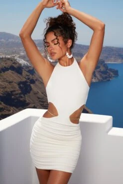 Midsummer Dreams Cut Out Waist Chain Mini Dress In Ivory -Glam Dress Store 4389 2 midsummer dreams ivory cut open side chain detailing halter ruched mini dress 1