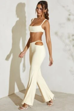 Twist Strap Cut Out Flare Trousers In Ivory -Glam Dress Store 5148 5 Callie Ivory Twost Cut Out Flare Trousers 98b68bdc 295f 4abf 8058 80d806b67e20
