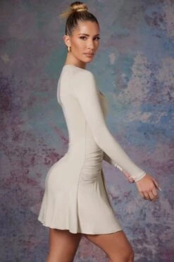 Long Sleeve Waterfall Skirt Mini Dress In Stone -Glam Dress Store 5473 5 Lili Stone Long Sleeve Halter Neck Mini Dress With Waterfall Skirt