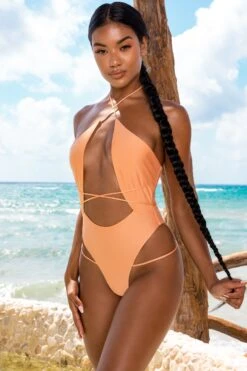 Secret Getaway Halter Neck Cut Out Swimsuit In Light Orange 21 Secret Getaway Halter Neck Cut Out Swimsuit In Light Orange -Glam Dress Store gg0004 2 secret getaway tan halterneck strappy swimsuit 1